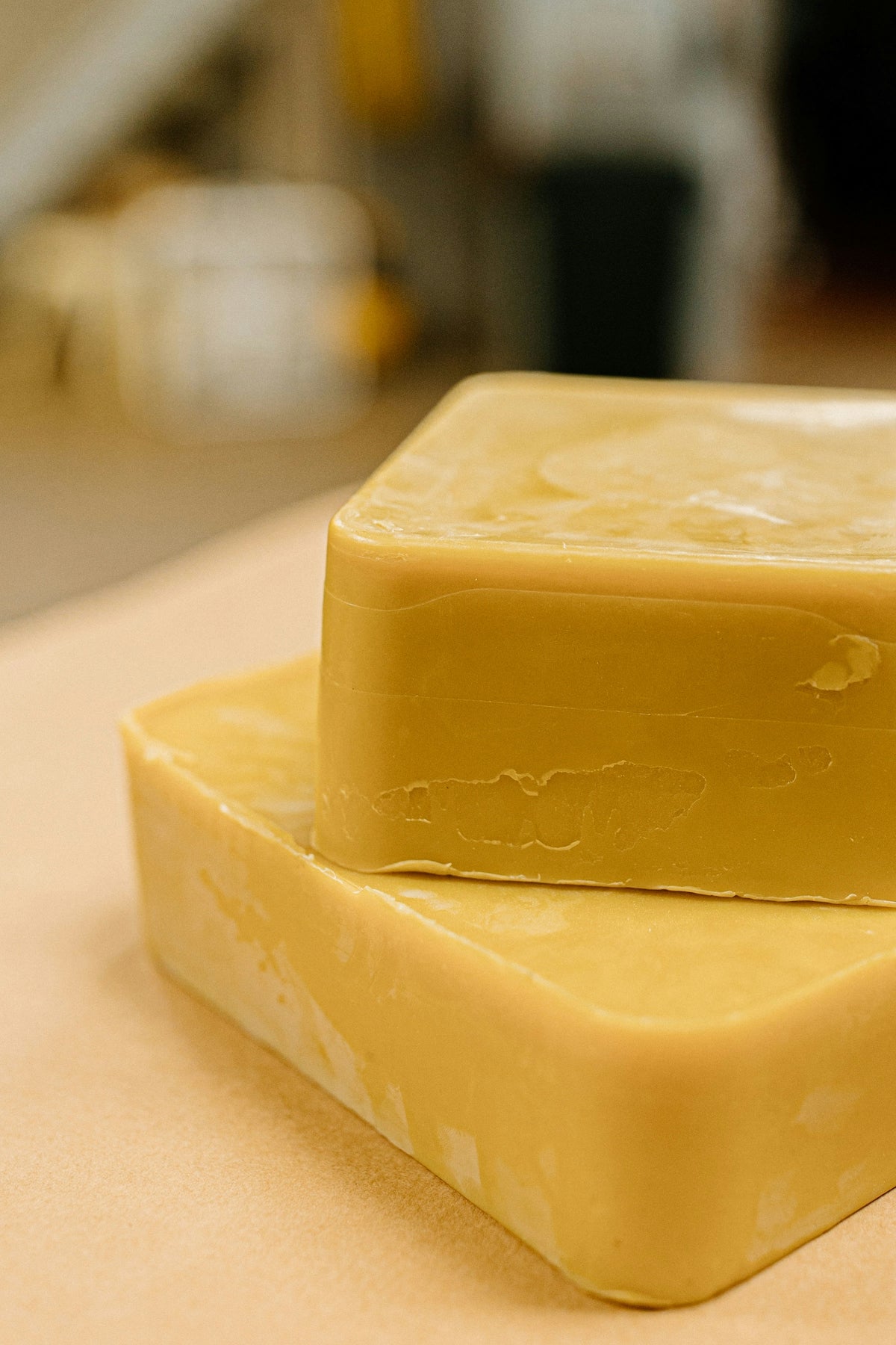 A couple of pieces of yellow soap sitting on top of a counter